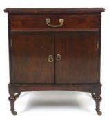 An early 20th century mahogany bedside cabinet with a drawer over two plain doors,