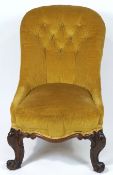 A Victorian button back nursing chair, on carved mahogany cabriole legs,