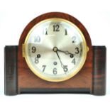 A German (Urgos) Westminster chiming clock, in walnut with domed case and black side motifs,