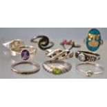 A collection of ten silver rings of variable designs, ranging in size from I to P.