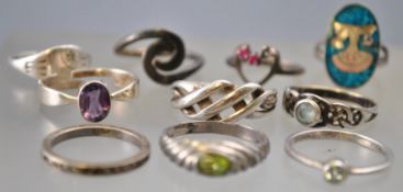A collection of ten silver rings of variable designs, ranging in size from I to P.