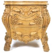 A French pine Louis XV style Rococo commode, deeply carved with acanthus, scrolls and flowers,