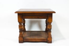 A mahogany cross banded square two tier occasional table on turned legs,