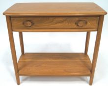 An Ercol elm wood rectangular side table (model No 1187) with shaped rectangular top