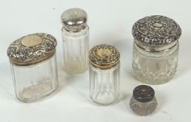 A group of five silver and white metal cut glass dressing jars, two gilt finish, two un-marked,