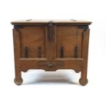 An Indian iron bound teak wood dowry chest, with hinged top above a frieze drawer,