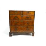 A George III veneered walnut chest of drawers with satinwood stringing with two short drawers above