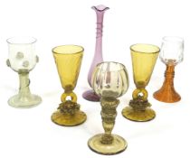 A group of six coloured drinking glasses,