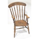 A farmhouse armchair with turned stick back and arm supports,