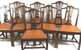 A set of eight mahogany dining chairs in George III style, with pierced and wheat sheaf splats,