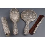 A ladies loaded silver dressing set, comprising : a hand mirror, two brushes and a comb,