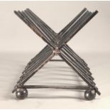 A Christopher Dresser style silver toast rack with saltire divisions, of plain square section,