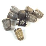 A group of seven assorted silver thimbles,