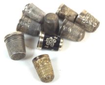 A group of seven assorted silver thimbles,