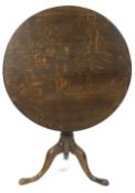 A George III oak tripod table, the tilt top on turned pedestal,