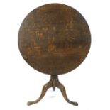 A George III oak tripod table, the tilt top on turned pedestal,