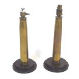 A pair of brass shell cases, mounted on stepped bakelite bases as table lamps,
