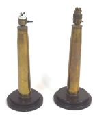A pair of brass shell cases, mounted on stepped bakelite bases as table lamps,