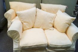 A three piece suite comprising two arm chairs and a two seater sofa
