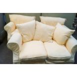 A three piece suite comprising two arm chairs and a two seater sofa