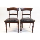 A matched set of four William IV mahogany chairs, each with rail backs,