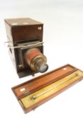 A mahogany magic lantern and a mahogany cased rolling ruler