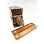 A mahogany magic lantern and a mahogany cased rolling ruler