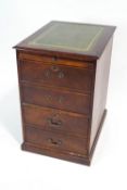 A small filing cabinet with leather inset top