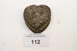 A silver heart shaped pill box