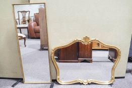A shaped gilt mirror and another