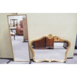 A shaped gilt mirror and another