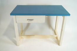A kitchen worktable with a blue formica top over a left hand drawer,