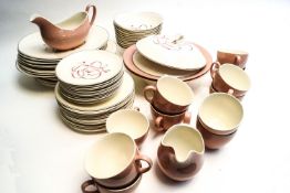 A mid-century modern table service by Johnson Brothers decorated with pink and grey ribbons on a