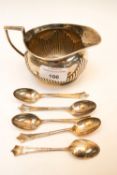 A silver jug and spoons