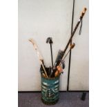 A painted umbrella stand with contents