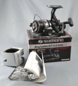 A Shimano 'Magnumlite GT-X2300' fixed spool reel in original box with spare spool