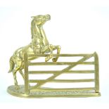 A brass figure of a horse jumping a five bar gate, styled as a letter rack,