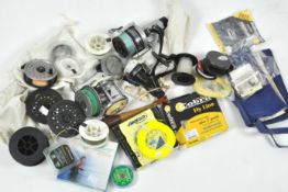 A collection of fly and fixed spool reels and various fly lures and other tackle