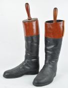 A pair of plastic life size hunting boots with simulated wooden trees,