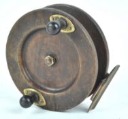 A hardwood fishing reel with ebonised handle,