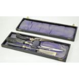 A cased carving set, the knife, steel and fork each with antler handles,