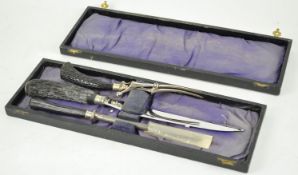 A cased carving set, the knife, steel and fork each with antler handles,