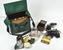 An Efgeeco 'Standard' tackle box containing assorted fixed spool and centre pin reels, nets,