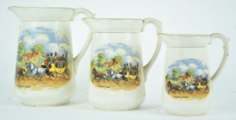 A suite of three graduated pottery jugs, transfer printed in colours with 'Dicken's Days',