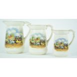 A suite of three graduated pottery jugs, transfer printed in colours with 'Dicken's Days',