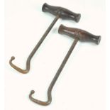 A pair of boot pulls with turned wood handles,