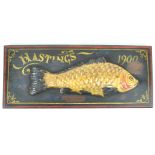 A composite half fish mounted on a painted mahogany board, 'Hastings 1900',