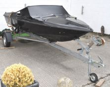 A John Player Special black fibreglass speed boat hull on an Auto Flex Knott type K 7.