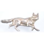 A white metal stock pin in the form of a running fox,