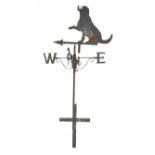 A cast and wrought iron weather vane with an ornament in the form of a seated gun dog,